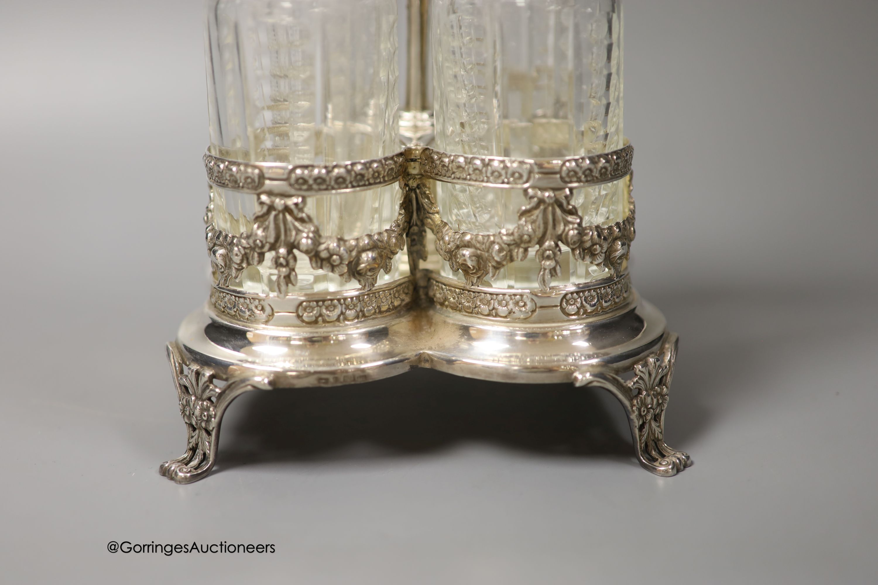 A 20th century Portuguese silver cruet stand, with four bottles, two with silver mounts, Oporto mark, height 30.5cm